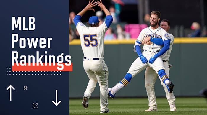 Seattle Mariners’ Jesse Winker, front right, is lifted by Ty France as he celebrates a win over Kansas City Royals in 12 innings of a baseball game, Sunday, April 24, 2022, in Seattle.